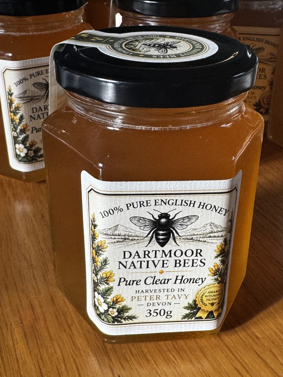 A jar of Pure Clear Honey, 350g, with the award seal on its label